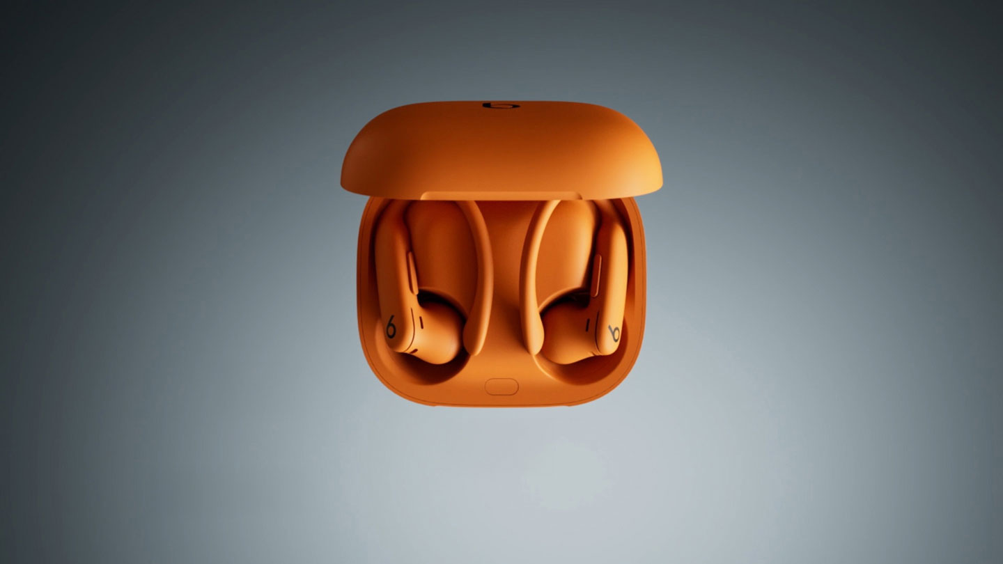 Pair of Electric Orange Powerbeats Pro 2 in an open case
