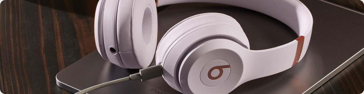 Close-up of Solo 4 headphones with charging cable
